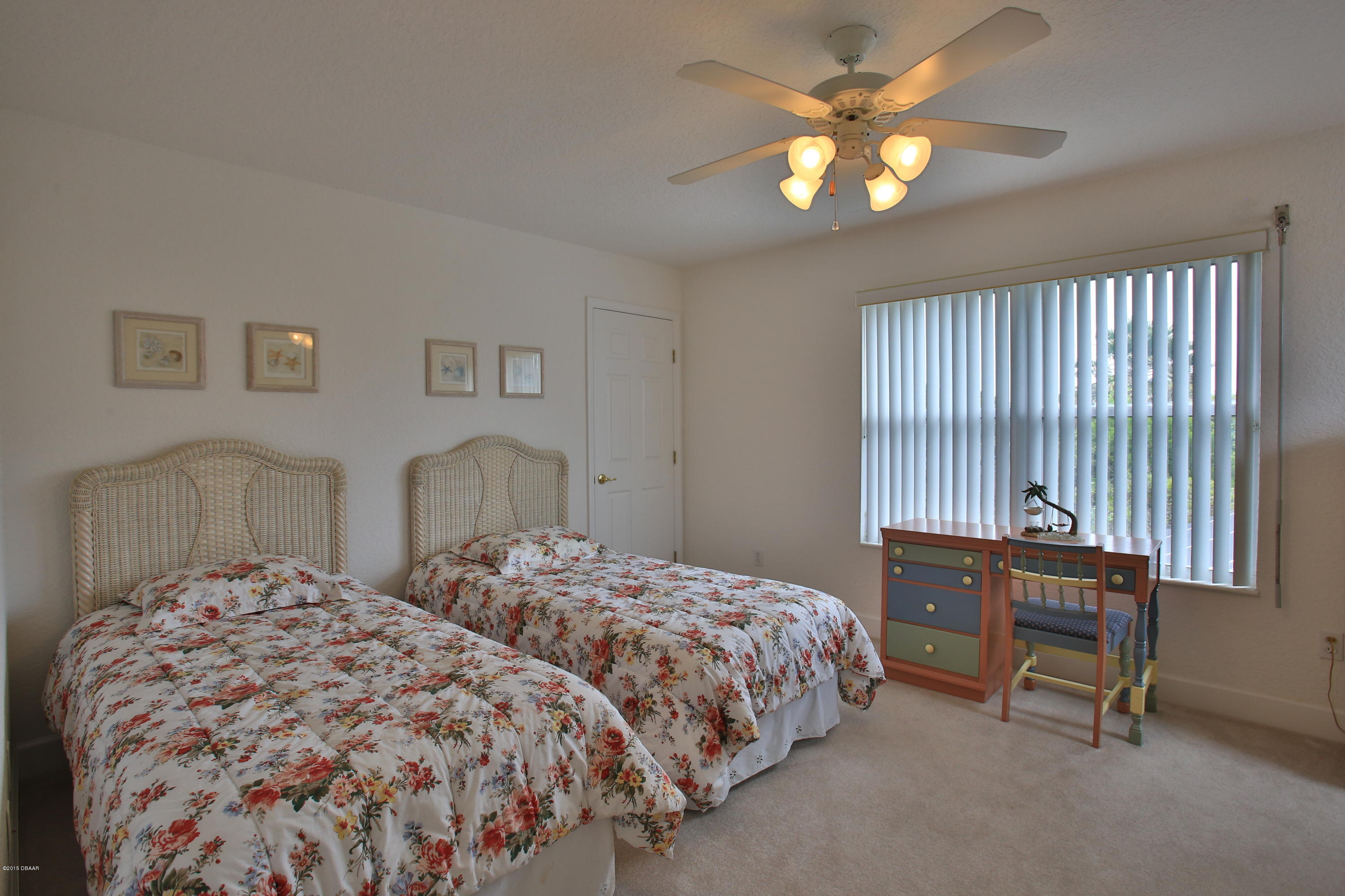 35 Inlet Point Boulevard Ponce Inlet, FL 32127 - Photo 16 of 34 a bedroom with two beds and a chandelier