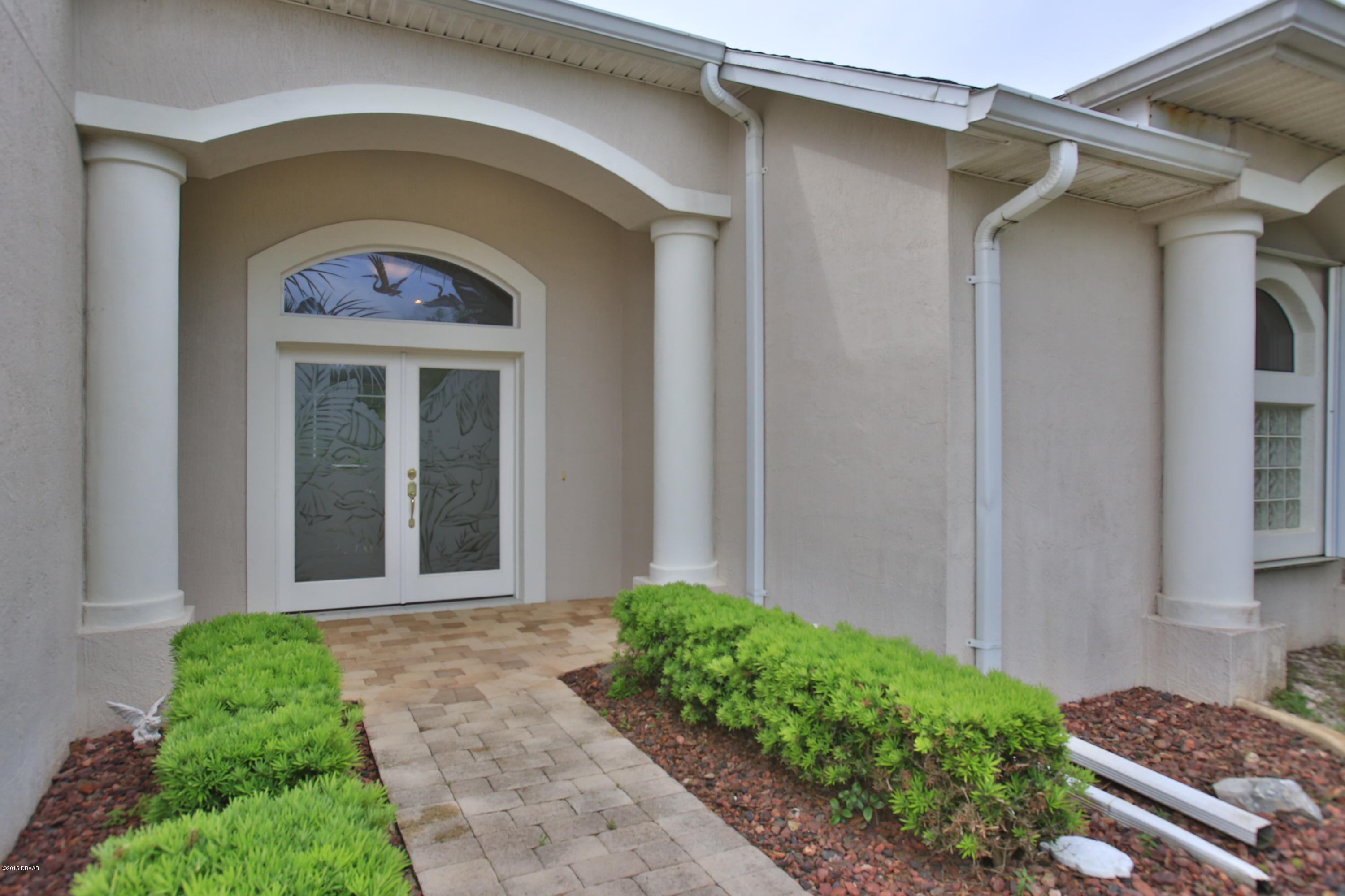 35 Inlet Point Boulevard Ponce Inlet, FL 32127 - Photo 2 of 34 a front view of a house with garden
