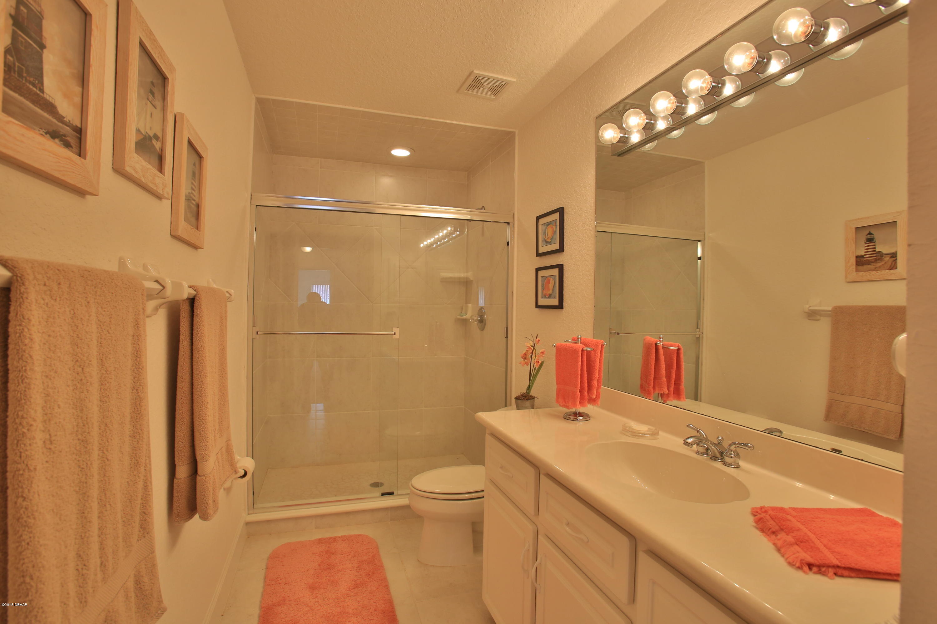 35 Inlet Point Boulevard Ponce Inlet, FL 32127 - Photo 22 of 34 a bathroom with a sink a toilet and shower