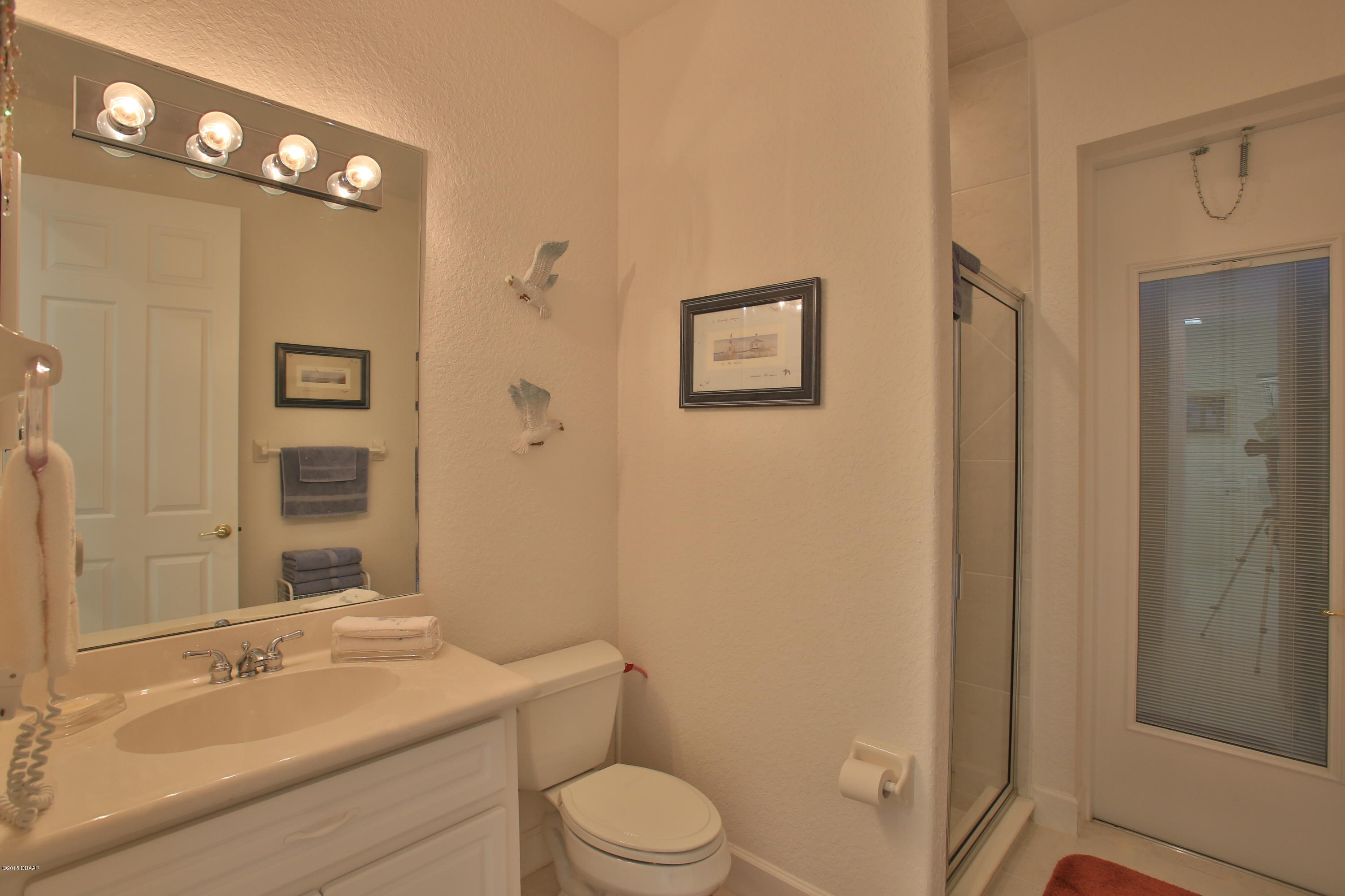 35 Inlet Point Boulevard Ponce Inlet, FL 32127 - Photo 25 of 34 a bathroom with a sink a toilet and shower