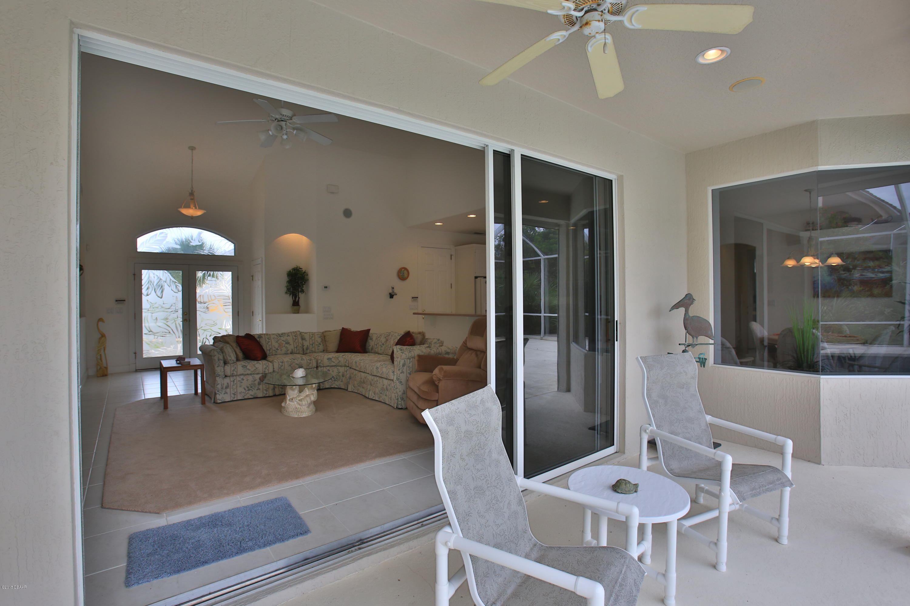 35 Inlet Point Boulevard Ponce Inlet, FL 32127 - Photo 26 of 34 a dining room with furniture and a chandelier