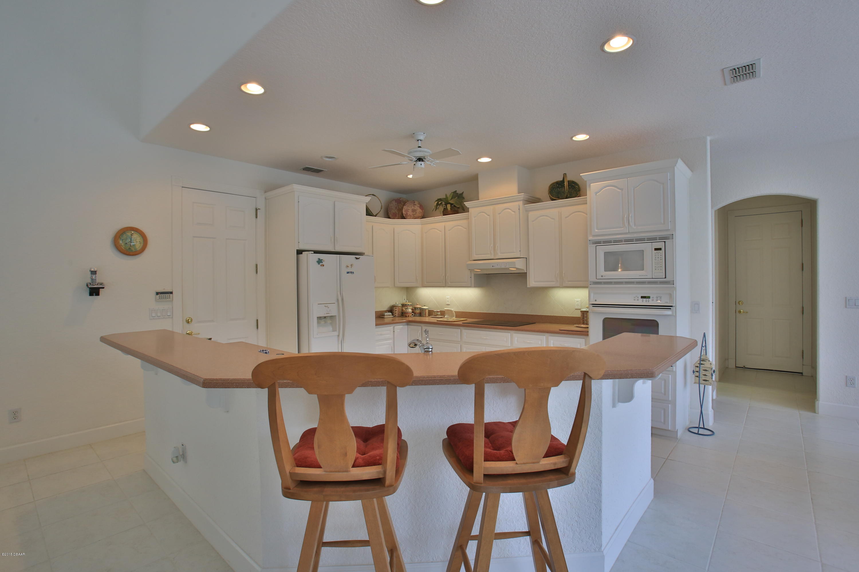 35 Inlet Point Boulevard Ponce Inlet, FL 32127 - Photo 6 of 34 a kitchen with stainless steel appliances granite countertop a sink and a refrigerator