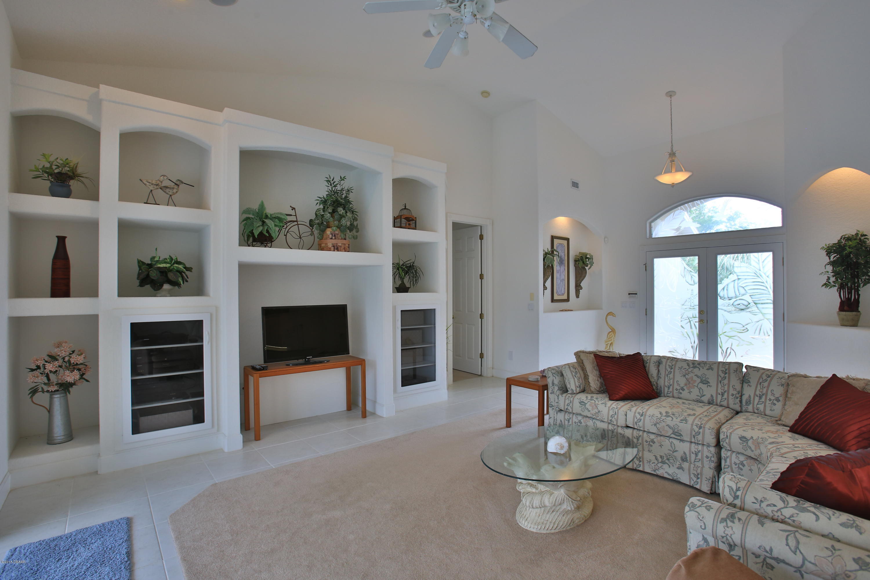 35 Inlet Point Boulevard Ponce Inlet, FL 32127 - Photo 8 of 34 a living room with furniture and a fireplace