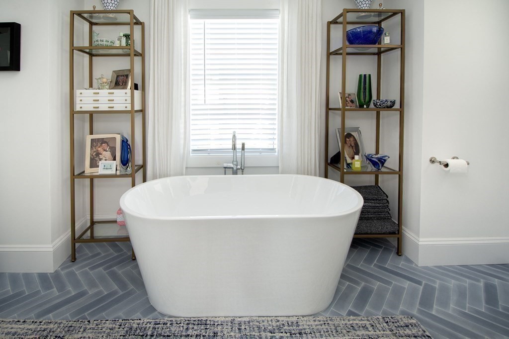 83 Glades Road Scituate, MA 02066 - Photo 15 of 37 a white bath tub sitting in a bathroom next to a window