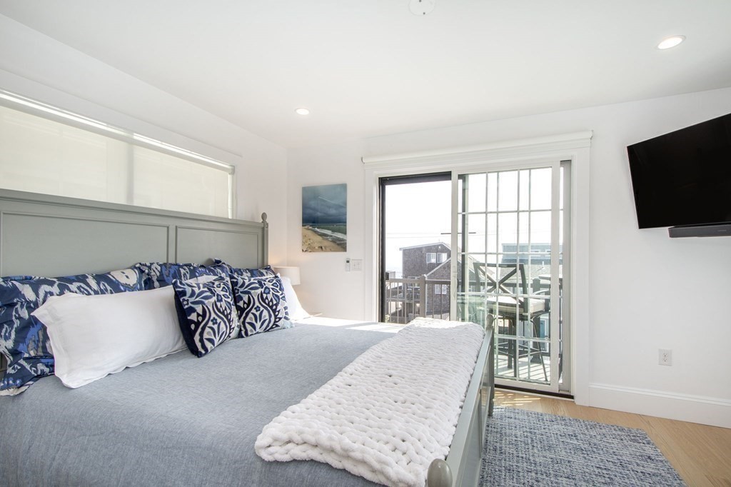 83 Glades Road Scituate, MA 02066 - Photo 18 of 37 a bedroom with a large bed and a flat tv screen on dresser