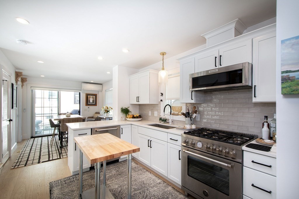 83 Glades Road Scituate, MA 02066 - Photo 25 of 37 a kitchen with a stove a sink and a microwave