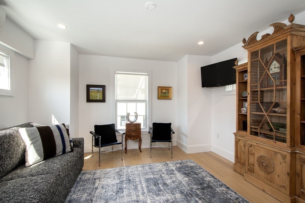 83 Glades Road Scituate, MA 02066 - Photo 28 of 37 a living room with furniture and a flat screen tv