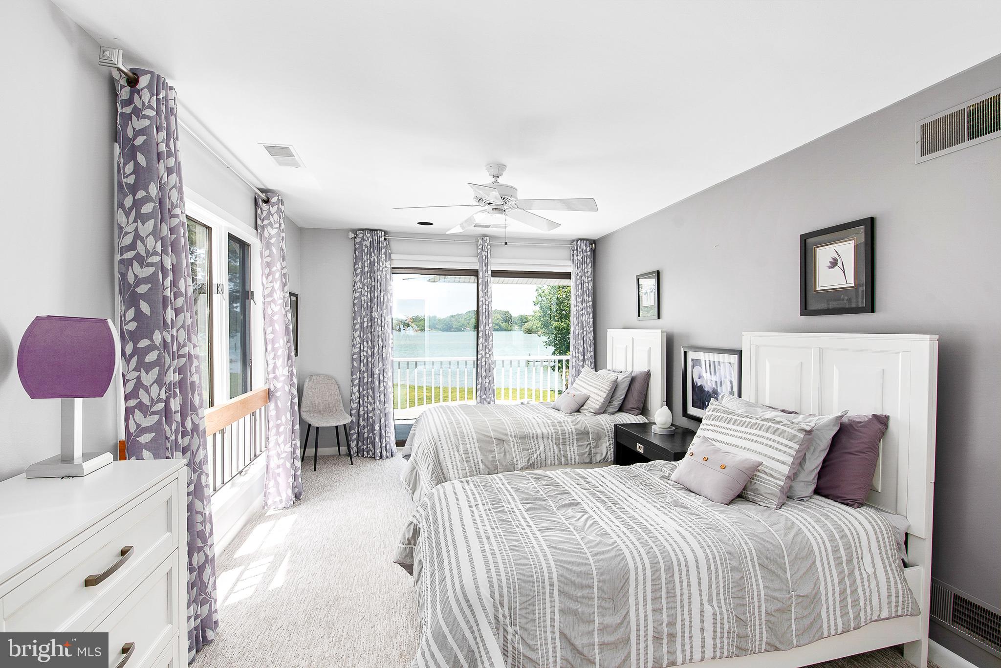 26282 Deep Water Harbor Road Easton, MD 21601 - Photo 31 of 53 a bedroom with a bed and a chandelier