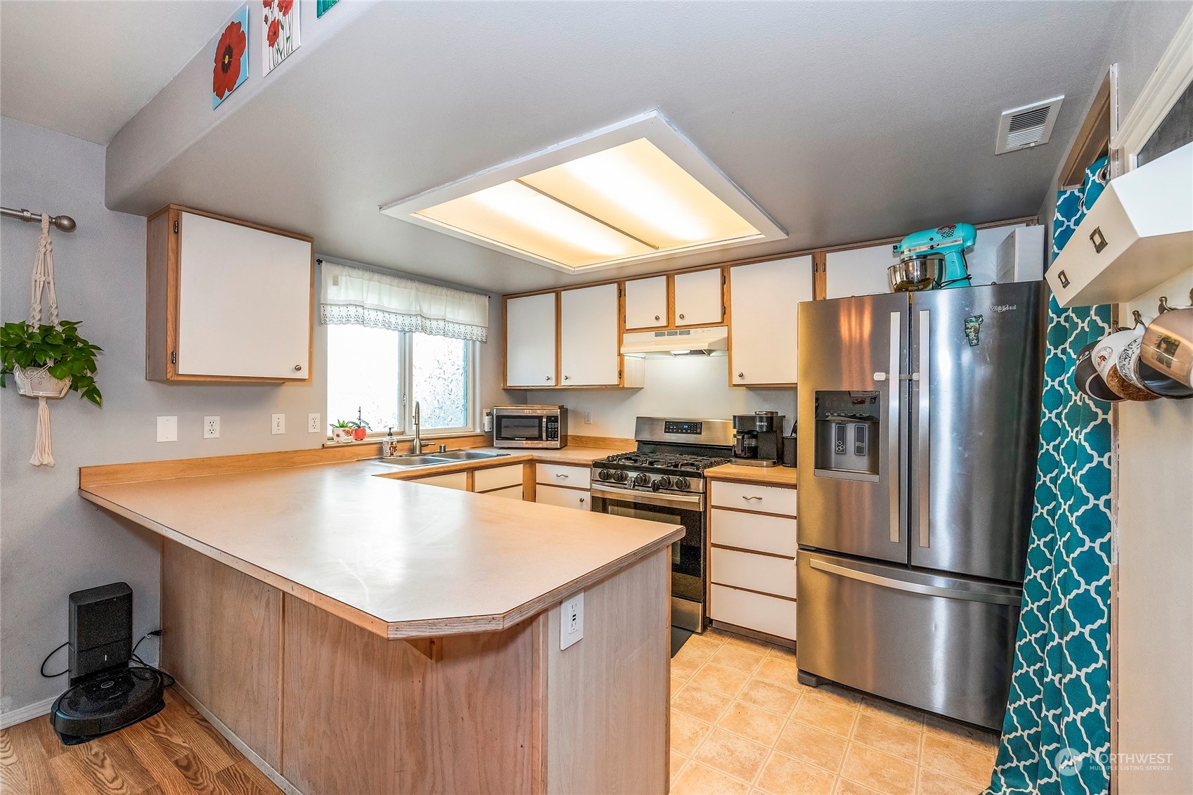 3992 Broadmoor Loop Bremerton, WA 98310 - Photo 11 of 34 a kitchen with stainless steel appliances a refrigerator sink and cabinets