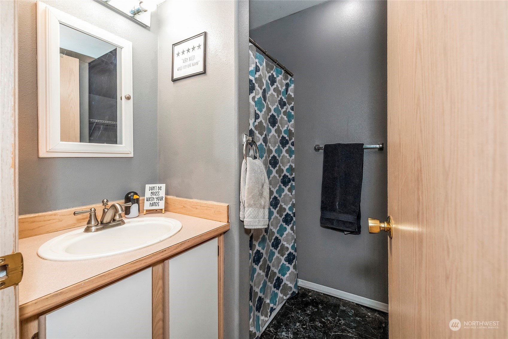 3992 Broadmoor Loop Bremerton, WA 98310 - Photo 12 of 34 a bathroom with a sink and a shower curtain