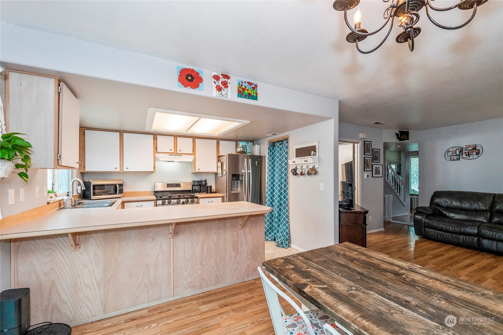 3992 Broadmoor Loop Bremerton, WA 98310 - Photo 8 of 34 a kitchen with kitchen island granite countertop a sink cabinets and wooden floor
