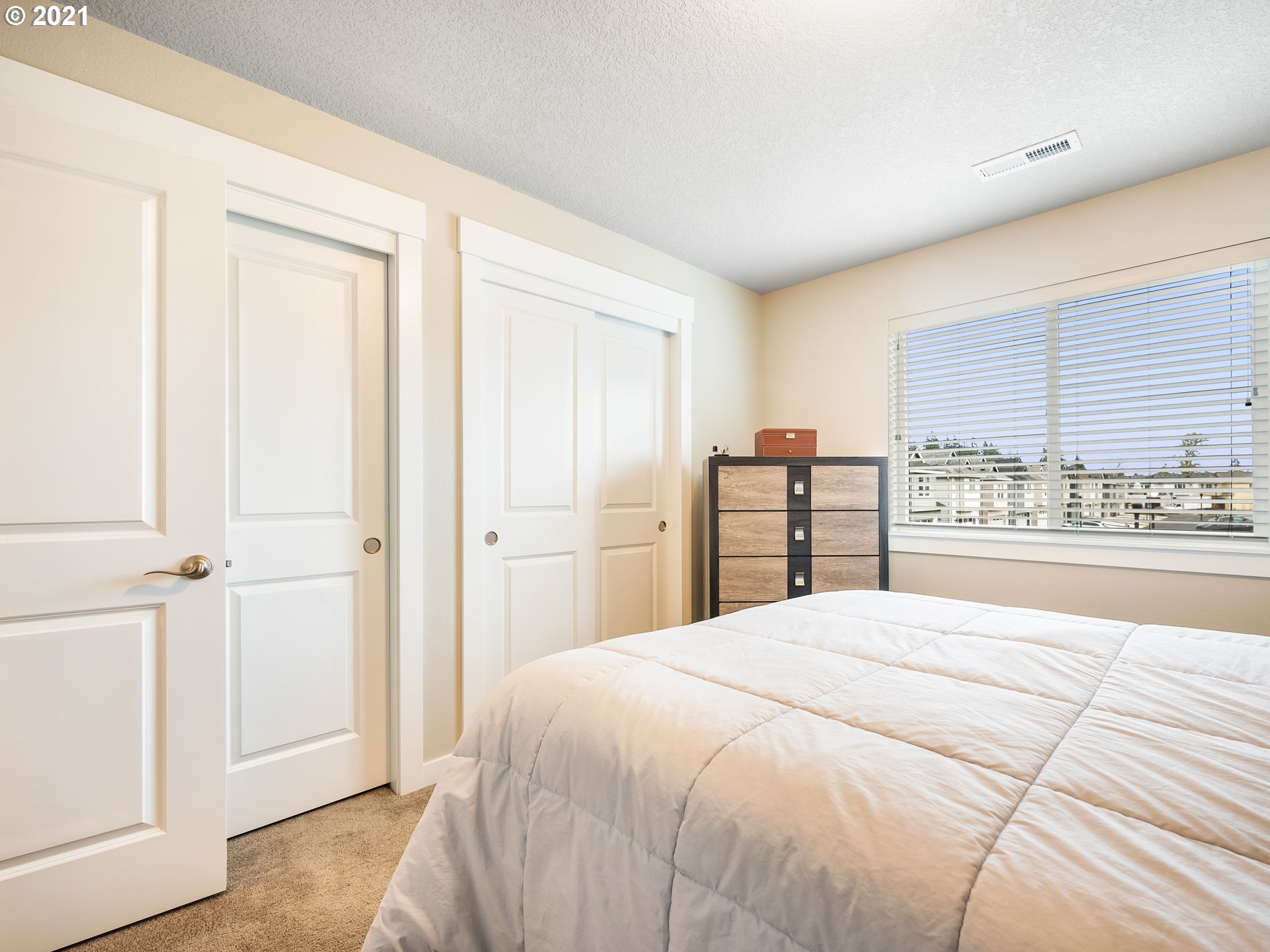 1133 South Union Place Ridgefield, WA 98642 - Photo 23 of 27 a large bedroom with a bed and a large window