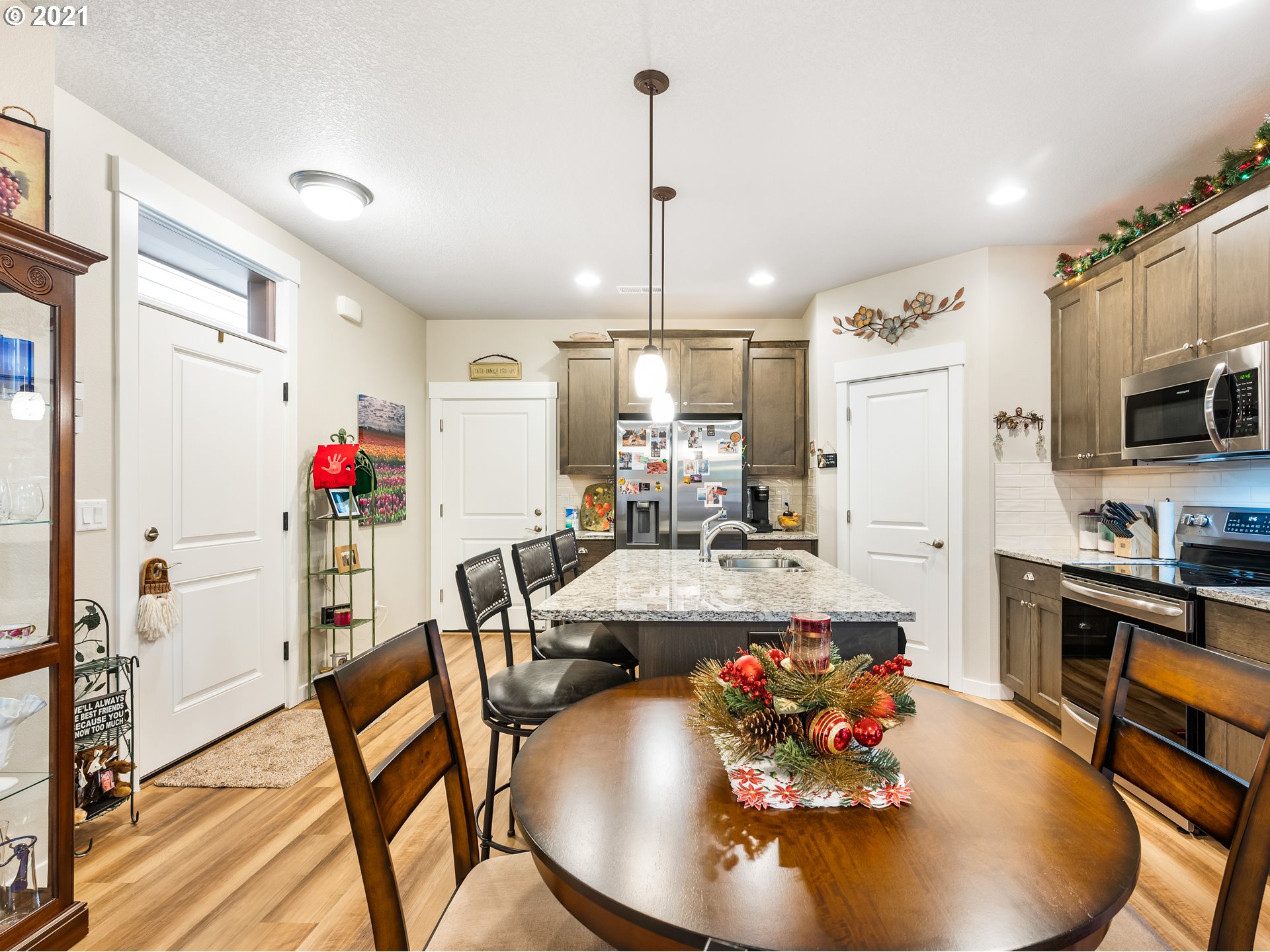 1133 South Union Place Ridgefield, WA 98642 - Photo 5 of 27 a very nice looking dining room with kitchen island furniture wooden floor and a chandelier