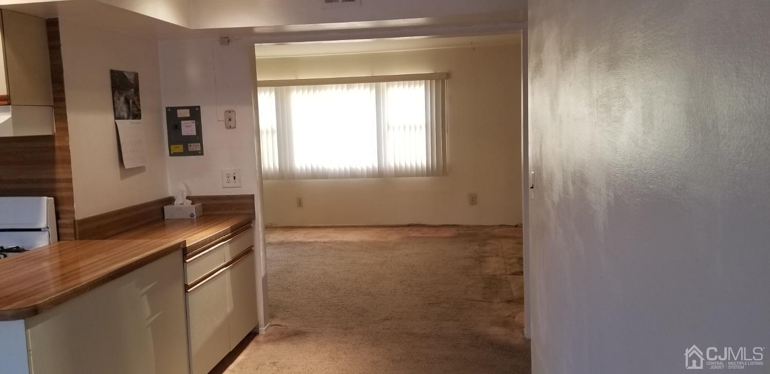 197 Evergreen Road, Unit 1A Edison, NJ 08837 - Photo 16 of 21 Carpeting being removed and Hardwood floors refinished.