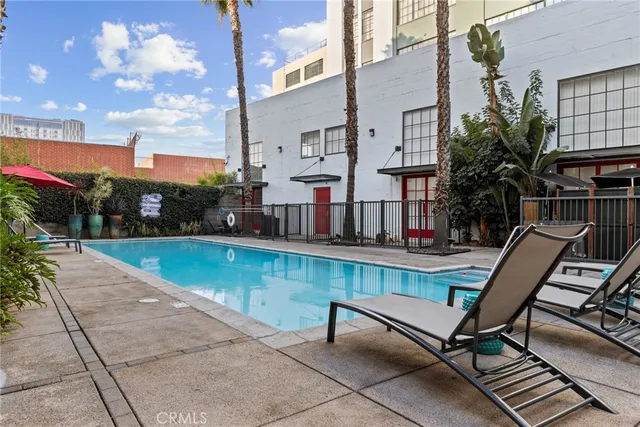 a view of swimming pool with outdoor seating and a yard