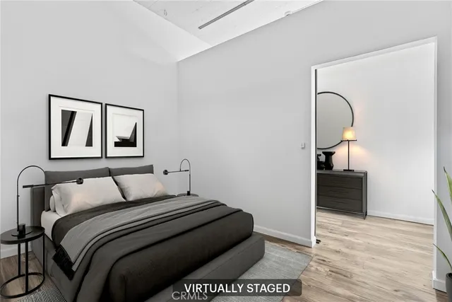 a bedroom with a bed and a painting on the wall