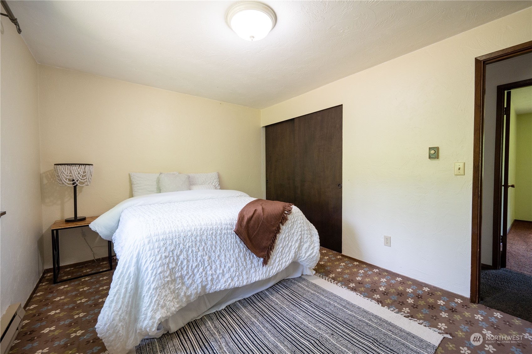 16935 Sargent Road Southwest Rochester, WA 98579 - Photo 10 of 18 a bedroom with a bed and wooden floor