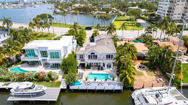 an aerial view of a house with swimming pool and outdoor seating