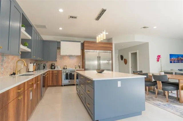 a stove top oven sitting inside of a kitchen