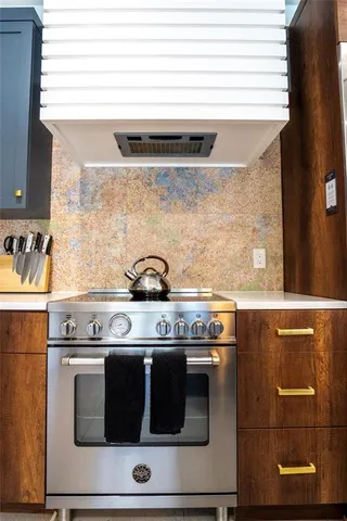 a large kitchen with a table and chairs