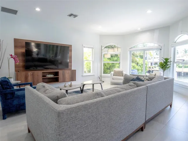 a bedroom with a bed and large window