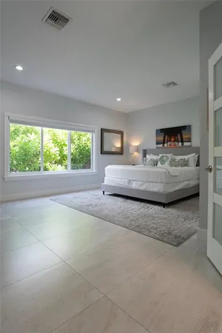 a bedroom with a bed and a flat screen television