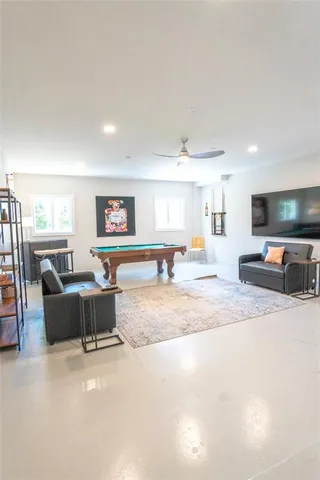 a room with pool table and windows