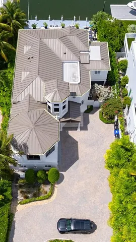 an aerial view of a house with yard and garage