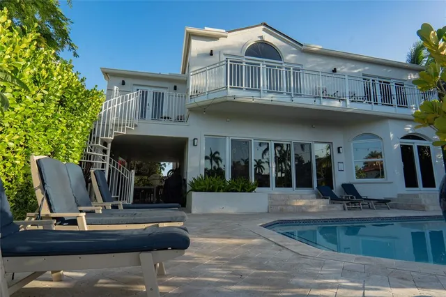 a view of a swimming pool with lounge chairs