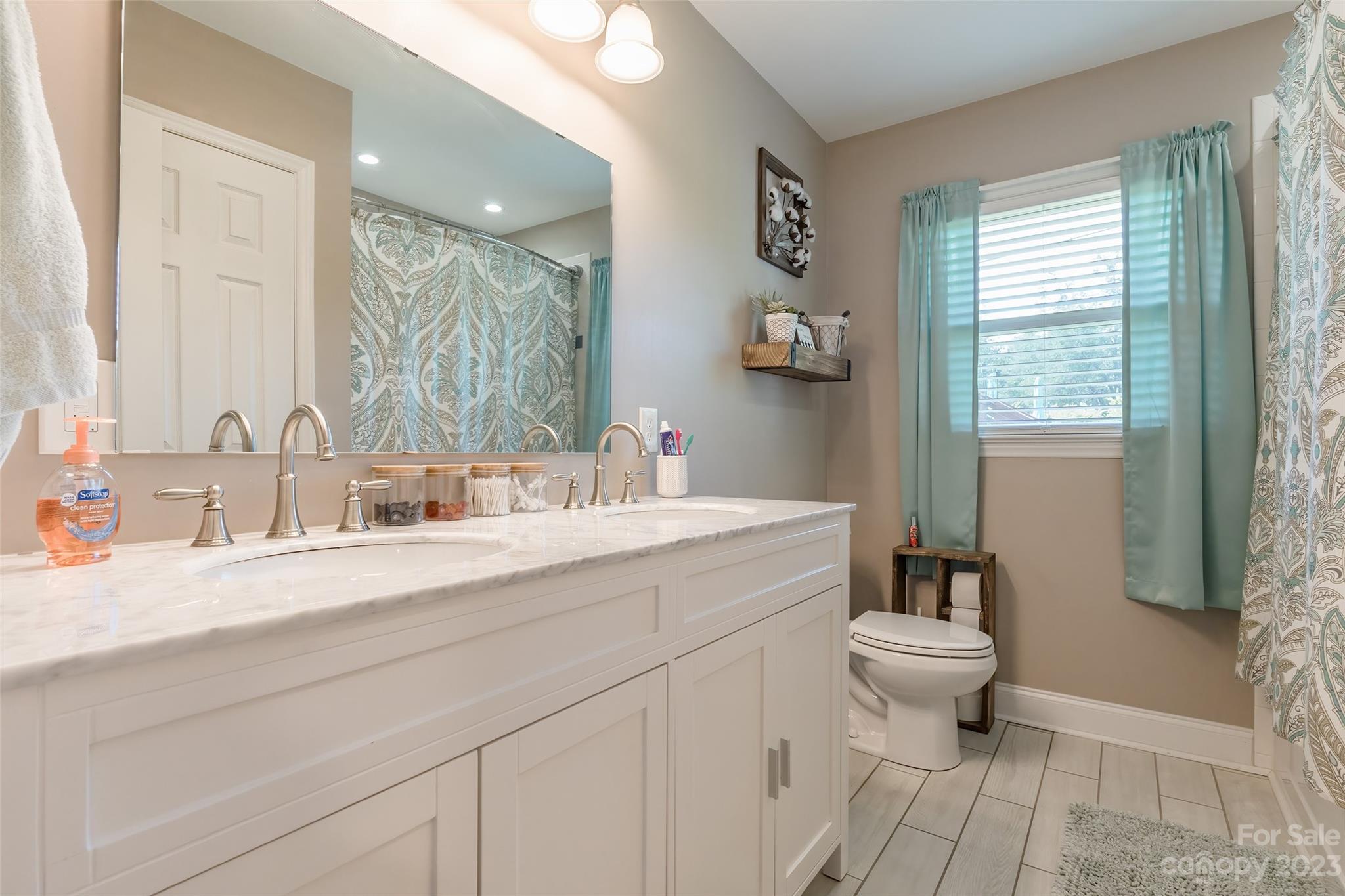 1514 Shiloh Unity Road Lancaster, SC 29720 - Photo 16 of 26 a bathroom with a sink toilet a mirror and shower