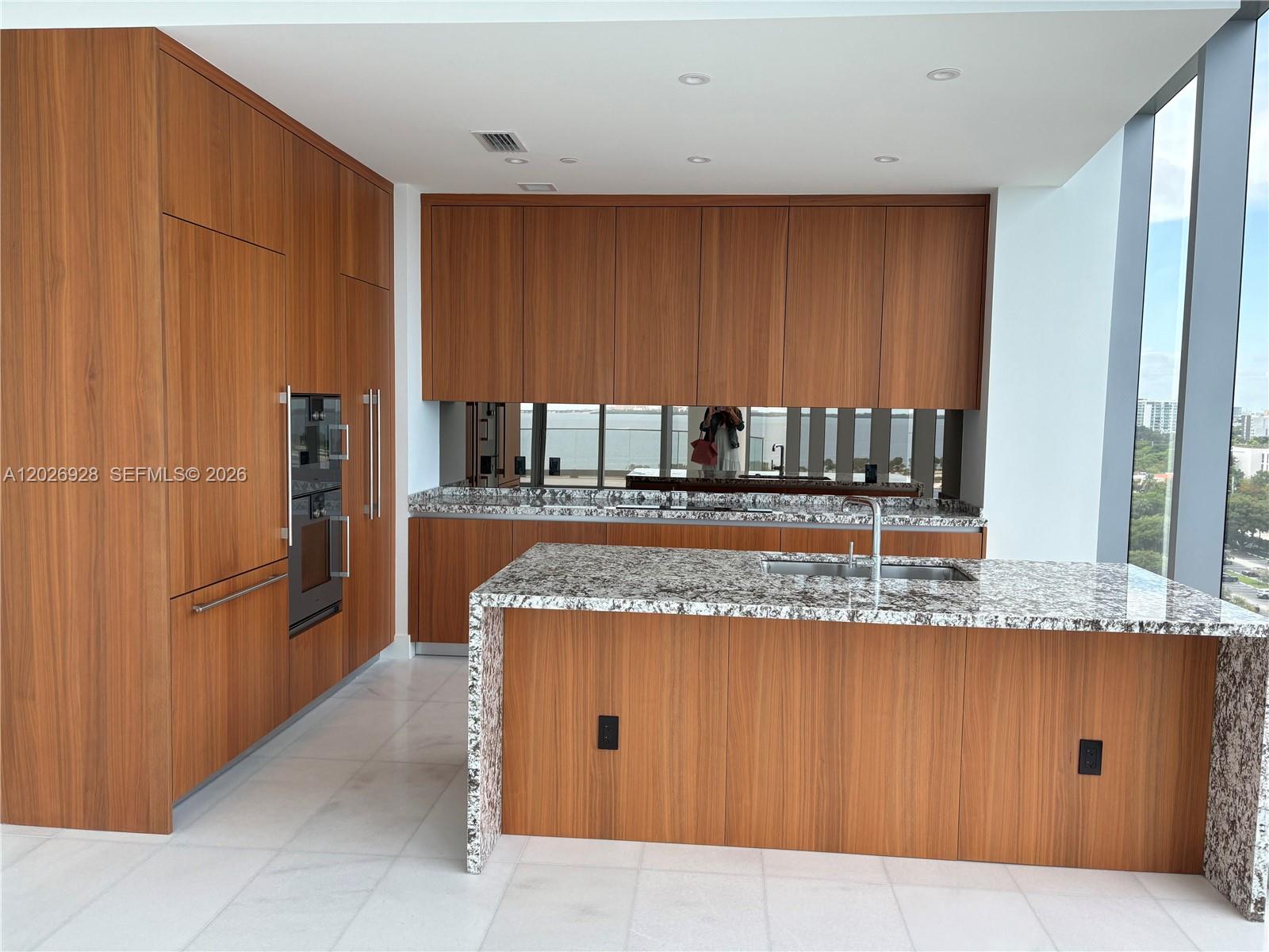 175 Southeast 25th Road, Unit 901 Miami, FL 33129 - Photo 7 of 18 a kitchen with stainless steel appliances granite countertop a granite counter tops and a view of living room