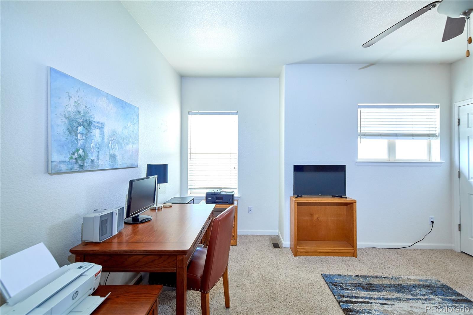 5800 Tower Road, Unit 610 Denver, CO 80249 - Photo 13 of 25 a view of a workspace with furniture and a window