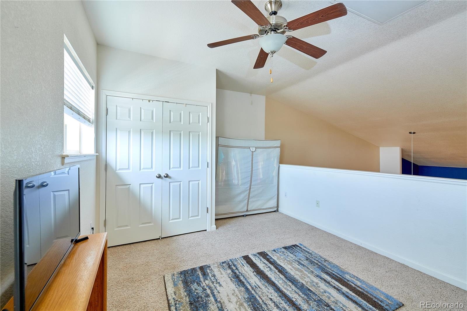 5800 Tower Road, Unit 610 Denver, CO 80249 - Photo 15 of 25 a view of empty room with wooden floor and fan