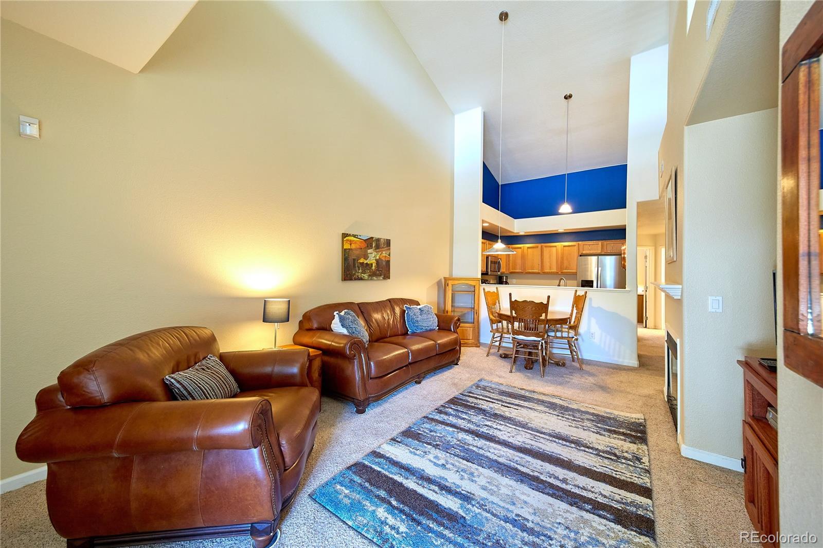 5800 Tower Road, Unit 610 Denver, CO 80249 - Photo 2 of 25 a living room with furniture and a fireplace
