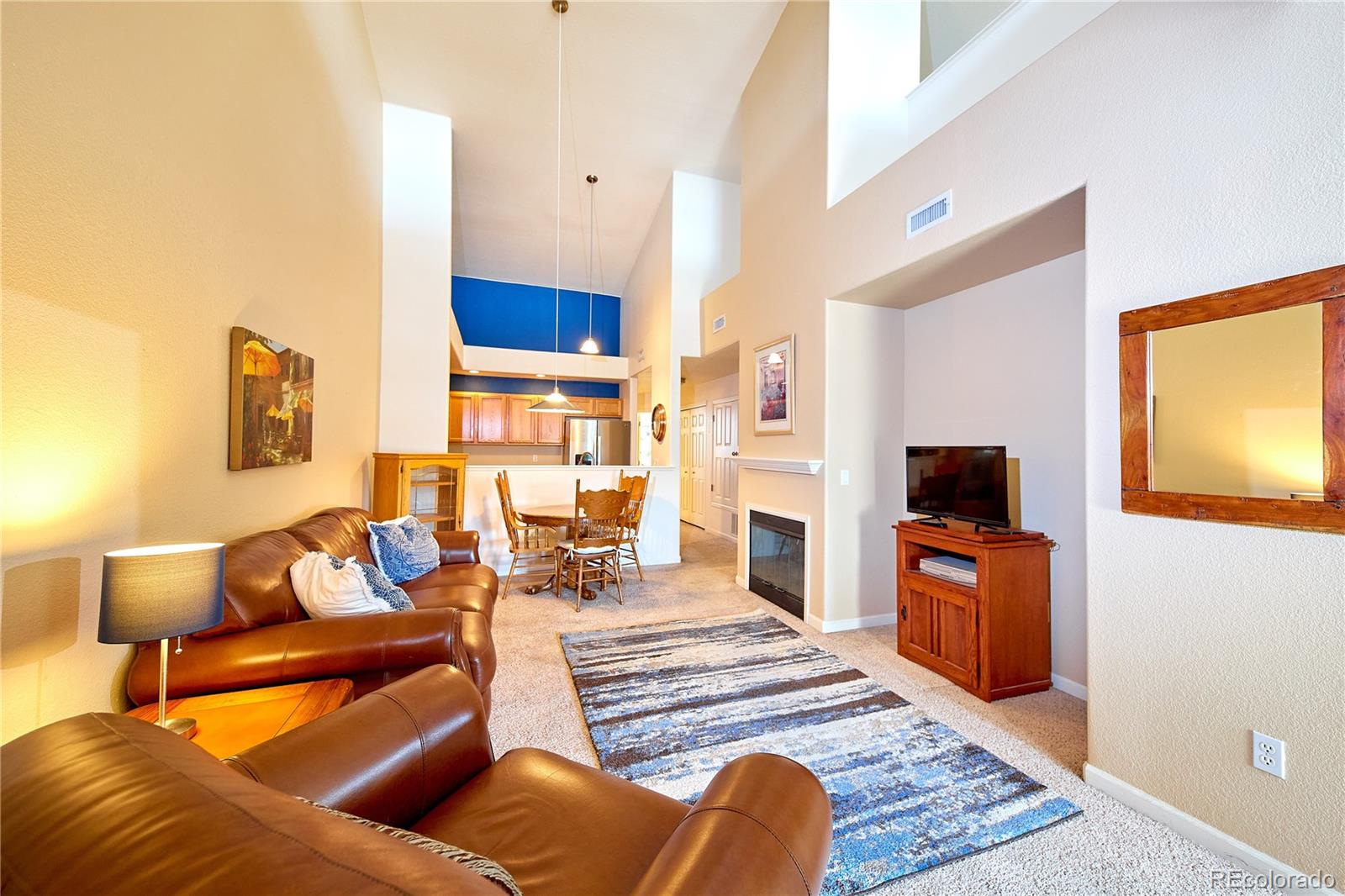 5800 Tower Road, Unit 610 Denver, CO 80249 - Photo 4 of 25 a living room with furniture and a flat screen tv