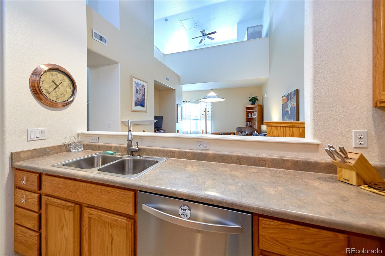 5800 Tower Road, Unit 610 Denver, CO 80249 - Photo 9 of 25 a kitchen with a sink and a wooden floor