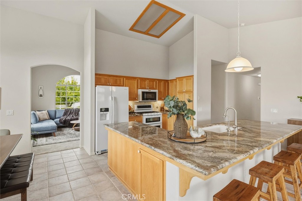 1608 Via Flora Paso Robles, CA 93446 - Photo 14 of 57 a kitchen with counter top space and living room view
