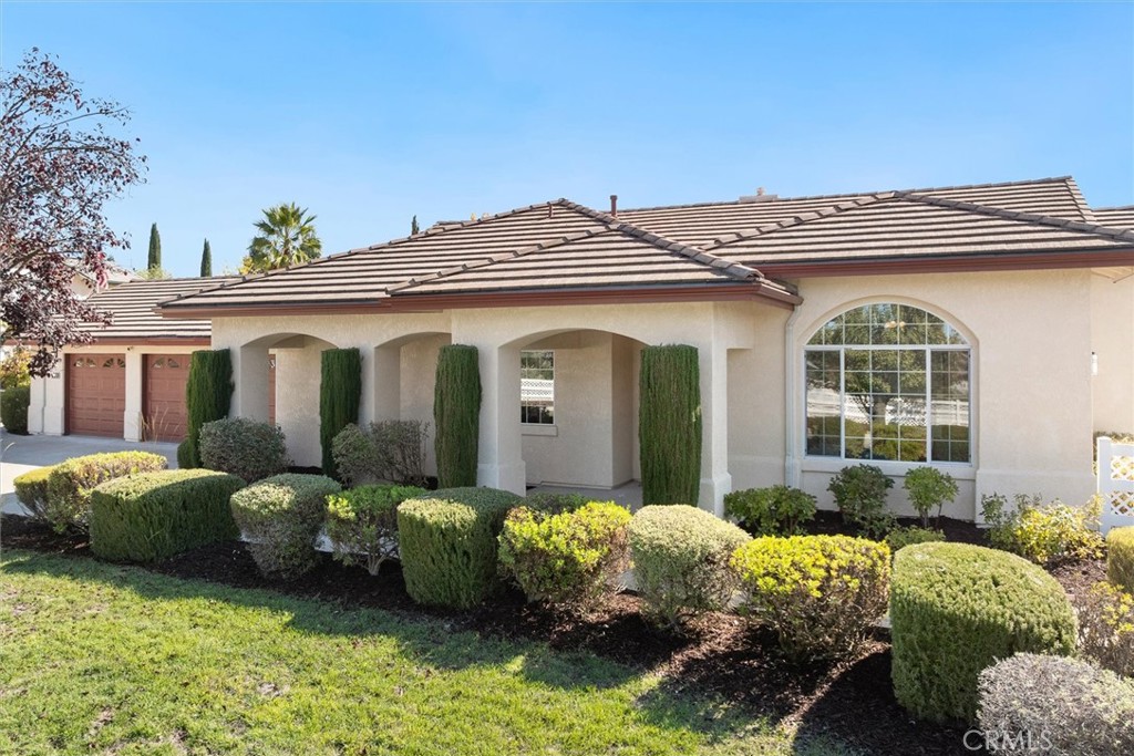 1608 Via Flora Paso Robles, CA 93446 - Photo 2 of 57 a front view of a house with a garden and plants