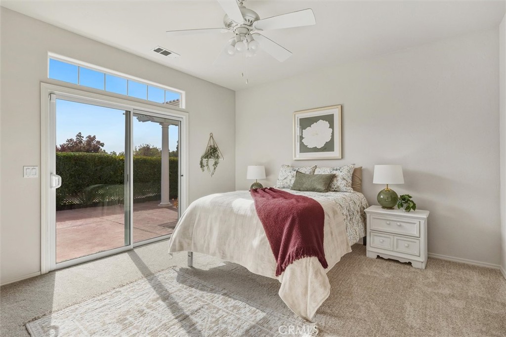 1608 Via Flora Paso Robles, CA 93446 - Photo 24 of 57 a spacious bedroom with a bed and glass window