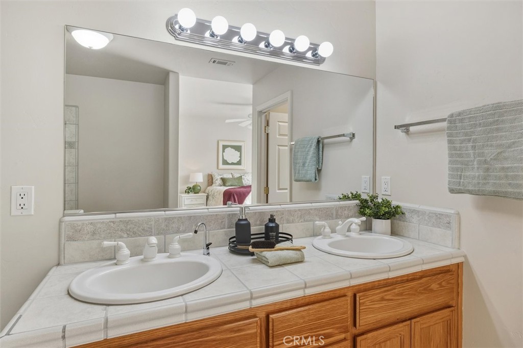 1608 Via Flora Paso Robles, CA 93446 - Photo 27 of 57 a bathroom with a sink double vanity and a mirror