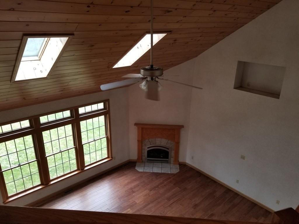 75 Cummings Road Ware, MA 01082 - Photo 30 of 37 a view of an empty room with wooden floor fireplace and a window