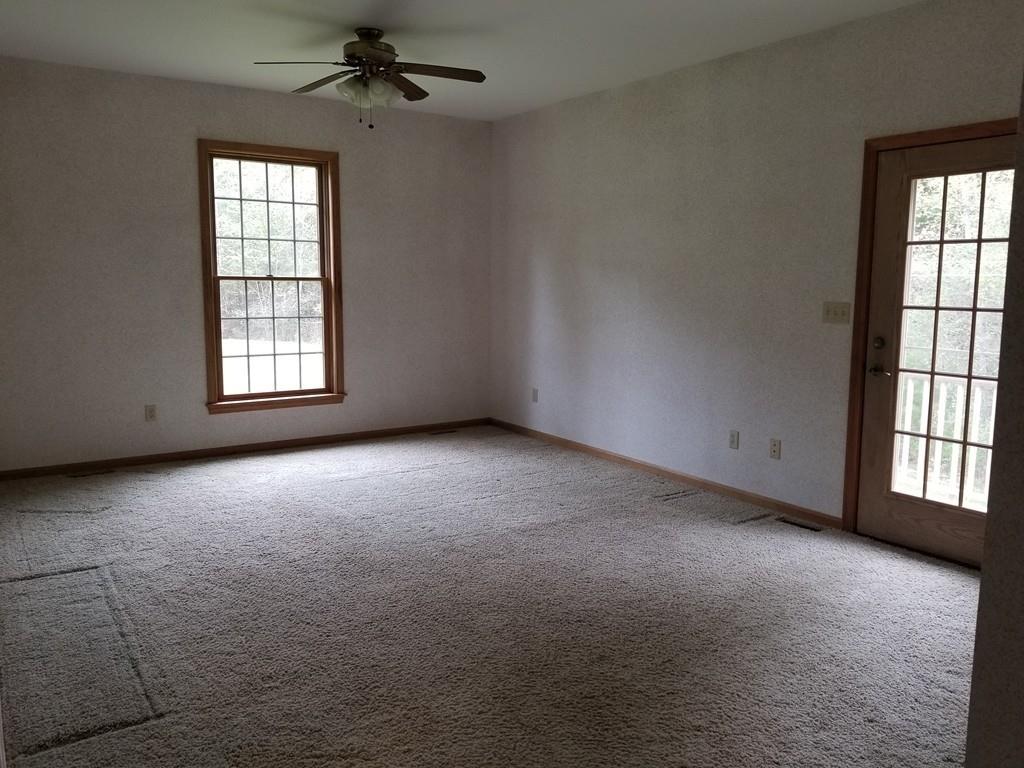 75 Cummings Road Ware, MA 01082 - Photo 35 of 37 an empty room with windows and chandelier fan