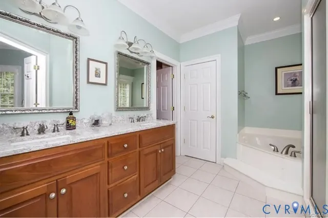 a spacious bathroom with a tub sink and mirror