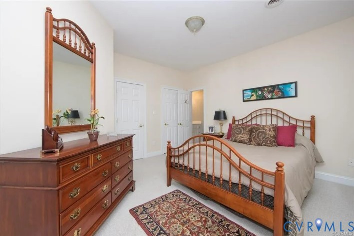 1638 Fallen Timber Trail Powhatan, VA 23139 - Photo 22 of 46 a bedroom with a bed and a dresser in it