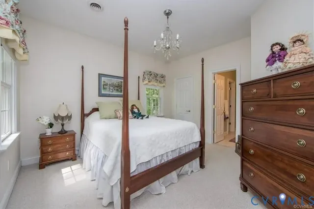 a spacious bedroom with a bed and a dresser