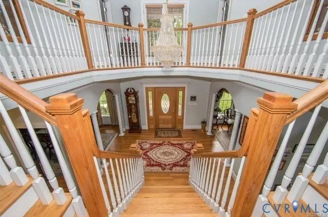 a view of a porch with wooden floor and furniture