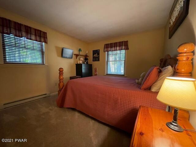 259 High Ridge Road Dingmans Ferry, PA 18328 - Photo 16 of 19 a bed sitting in a bedroom next to a window