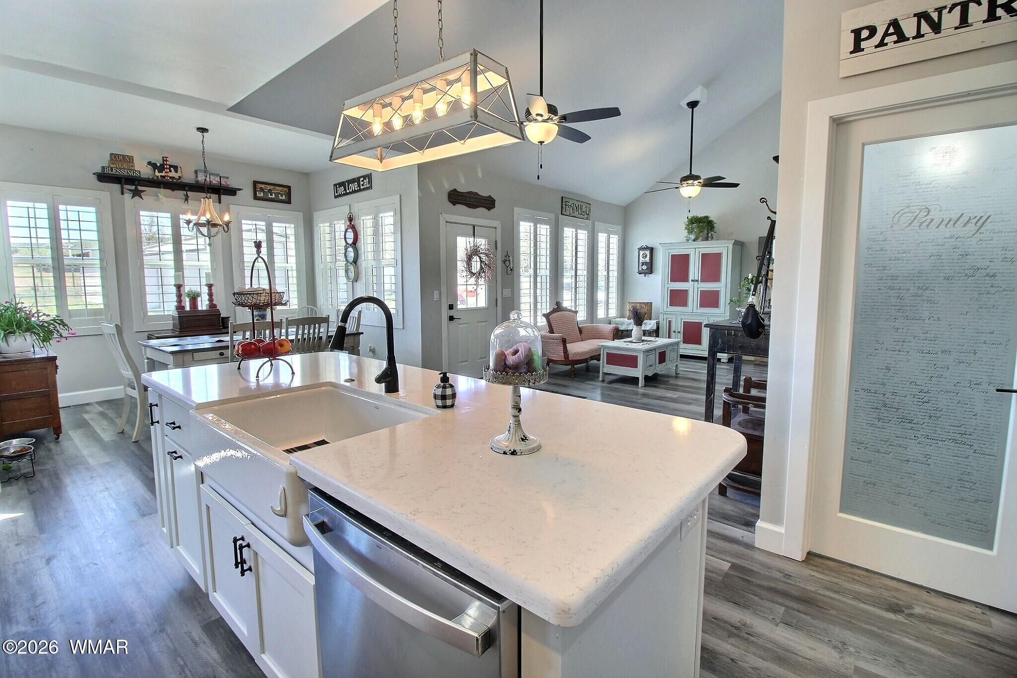 5325 Pinedale Wash Road Pinedale, AZ 85934 - Photo 11 of 32 a kitchen with stainless steel appliances a table chairs and wooden floor