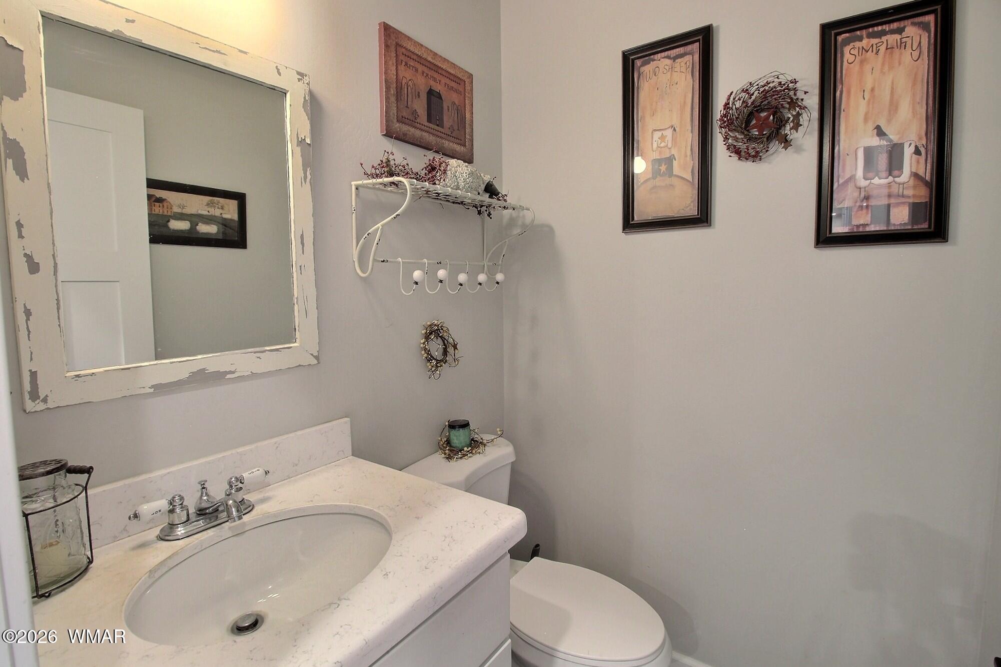 5325 Pinedale Wash Road Pinedale, AZ 85934 - Photo 20 of 32 a bathroom with a sink and mirror with toilet