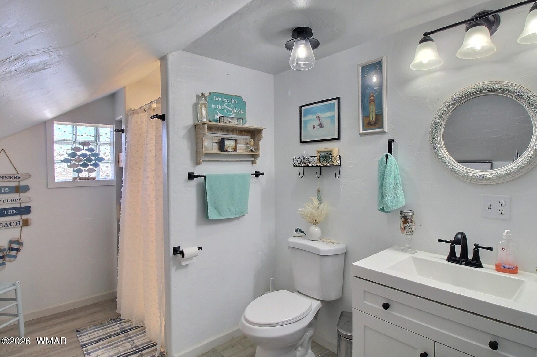 5325 Pinedale Wash Road Pinedale, AZ 85934 - Photo 24 of 32 a bathroom with a granite countertop toilet sink and mirror